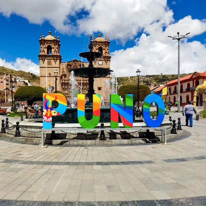 Colourful Puno lettering in the Plaza de Armas, with the cathedral behind