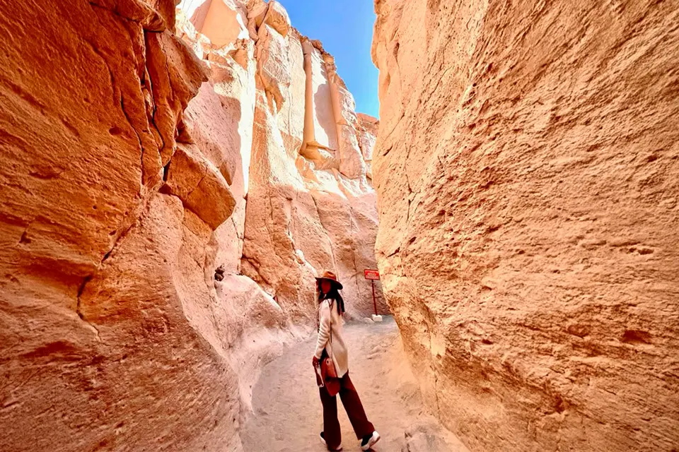 A visitor walking between the narrow rock walls of Culebrillas