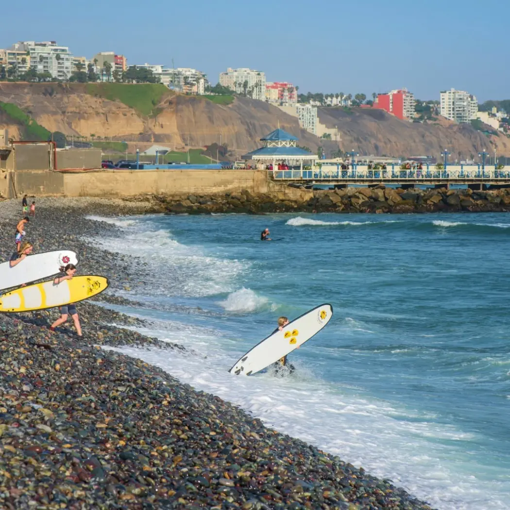 Surfboards and the pebble shore below the Miraflores cliffs