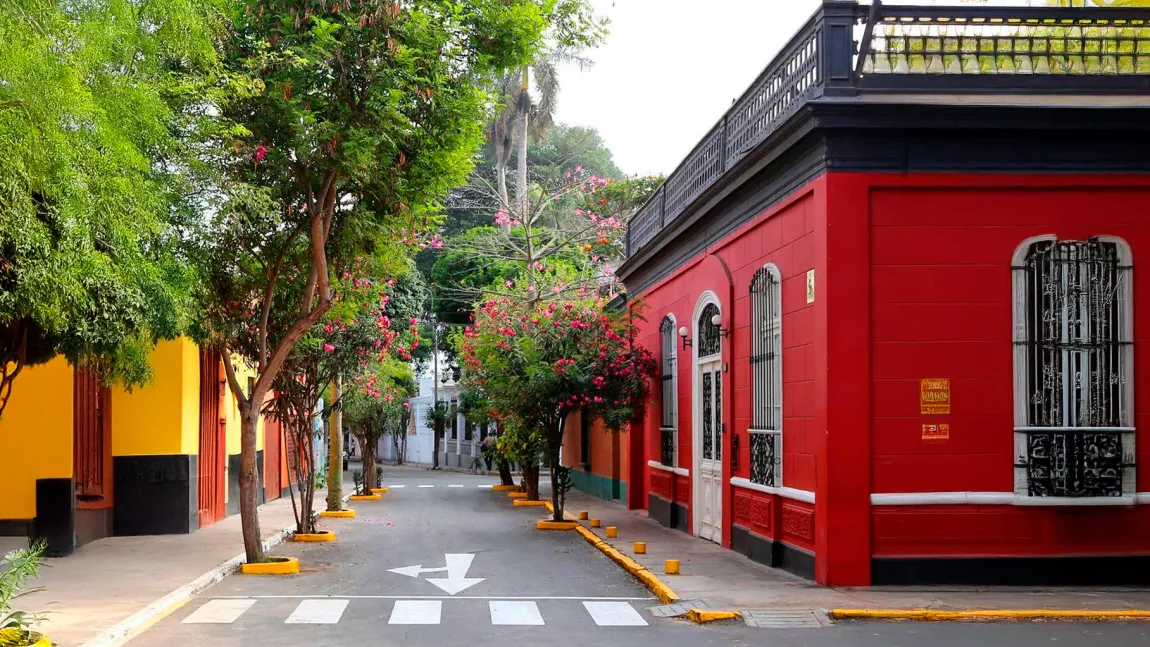 A leafy Barranco street with coloured historic facades