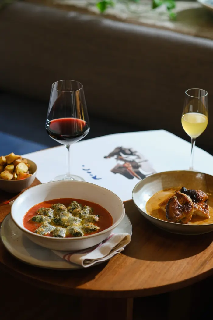 A table of dishes and wine in a photograph published by Rocco