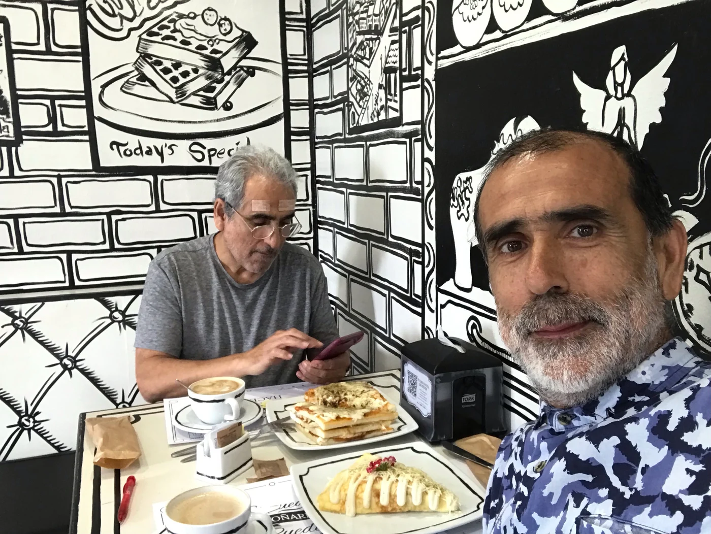 Fernando sharing a café table with a travel companion.