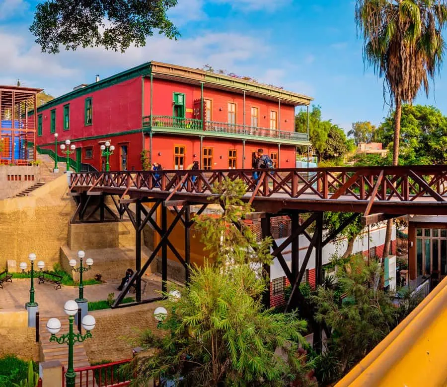 The wooden Bridge of Sighs beside a red Barranco casona