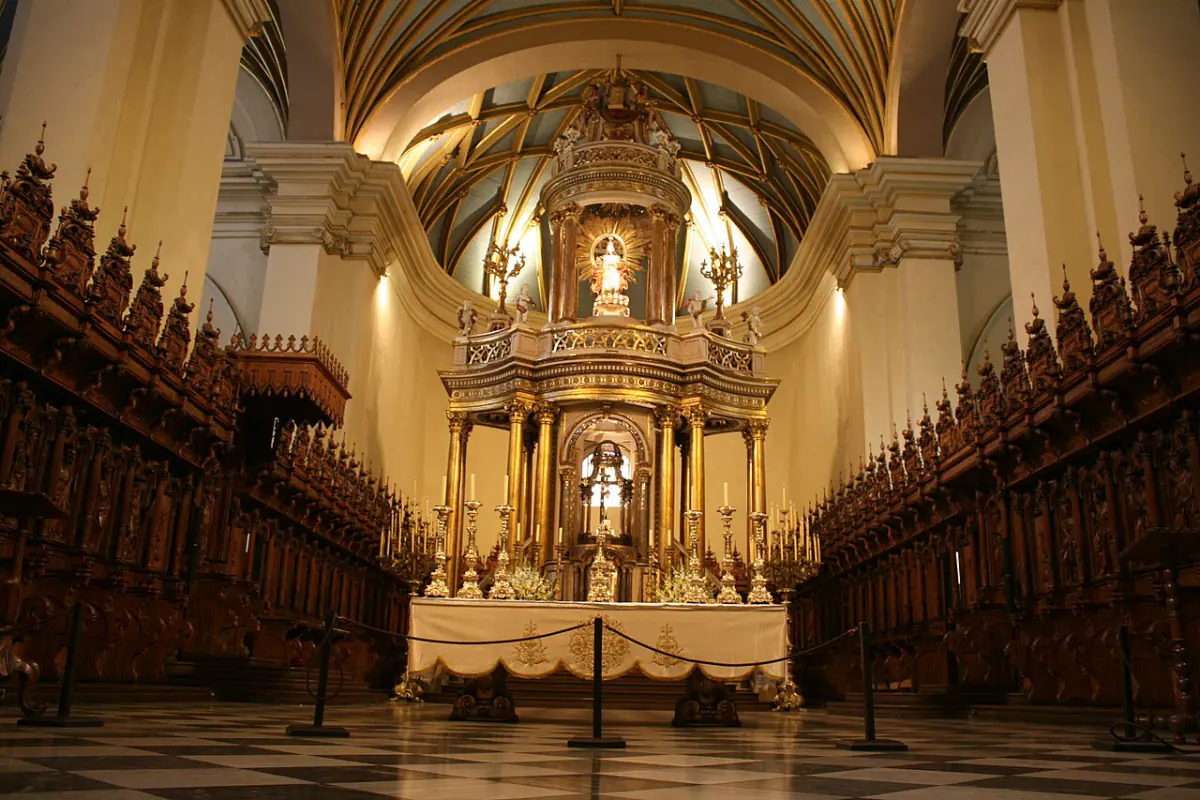 Carved wooden choir stalls on either side of the altar in Lima Cathedral.