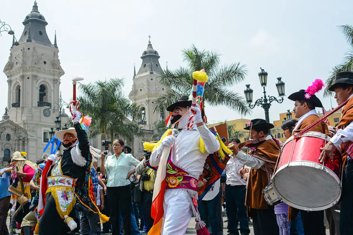 Dancers in regional dress performing before Lima Cathedral at a past cultural event.