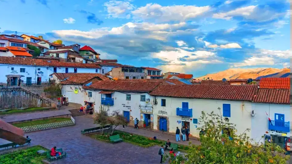 San Blas square, whitewashed houses with blue doors, terracotta roofs and the surrounding Cusco hills.