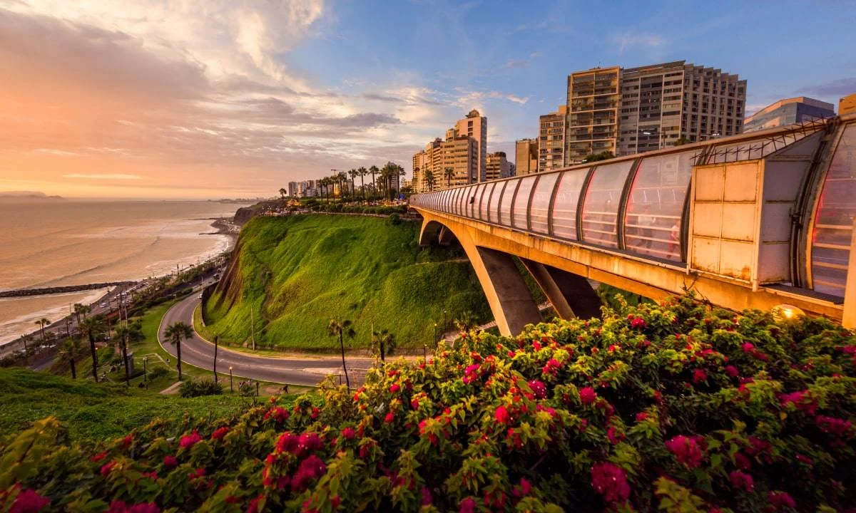 Golden evening light across the Miraflores cliffs and pedestrian bridge